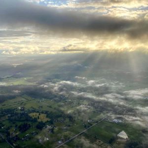 Yellow tinted sunrise with fog on the ground. View from a hot air balloon launching in Auburn, WA