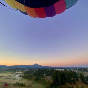 Yellow tinted sunrise with fog on the ground. View from a hot air balloon launching in Auburn, WA