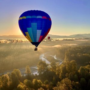 Two balloons with one blocking the sun, causing an eclipse