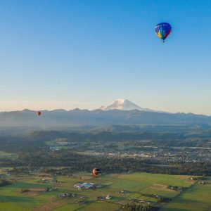 Three hot air balloons launching for a sunset flight in Seattle